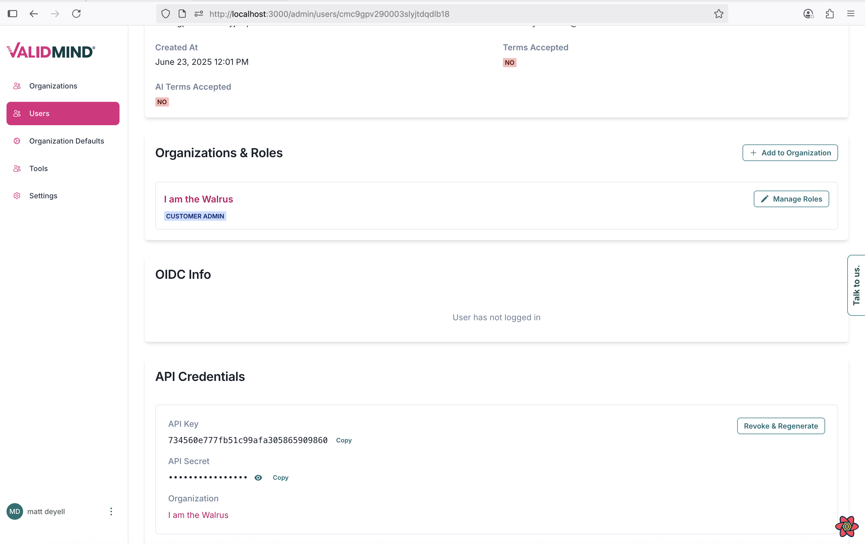 A web interface for managing user details is displayed. The top section shows user information with labels for Created At and Terms Accepted, followed by a section titled Organizations & Roles containing a role labeled I am the Walrus and a blue button labeled Add to Organization. Below is a section titled OIDC Info with a message stating User has not logged in. The API Credentials section includes fields for API Key and API Secret with options to copy each, and a button labeled Revoke & Regenerate. The interface uses a clean layout with a white background and pink accents for buttons and labels.