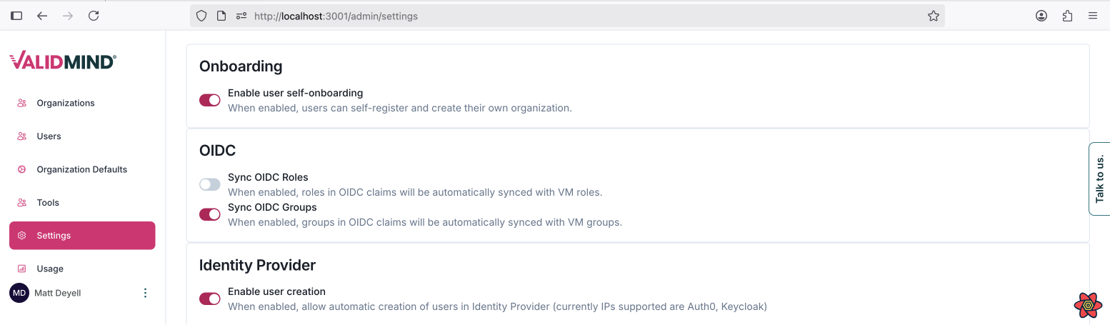 The image shows a web interface for ValidMind with a sidebar on the left and main content on the right. The sidebar includes a logo at the top, followed by menu items such as Organizations, Users, Organization Defaults, and Settings, with the Settings menu expanded to reveal a sub-item called Model Dev1. The main content area is titled Onboarding and contains three sections: OIDC, and Identity Provider, each with a brief description and toggle switches for enabling features. The Onboarding section has a toggle for enabling user self-onboarding, the OIDC section includes options for syncing OIDC roles and groups, and the Identity Provider section allows enabling user creation. Below the main content, a browser developer tools panel is open, displaying network activity with columns for status, type, and size.